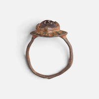 Byzantine bronze ring 'Porphyra' shows its raised purple setting above the complete hoop in profile.