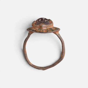 Byzantine bronze ring 'Porphyra' shows its raised purple setting above the complete hoop in profile.