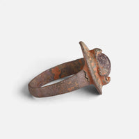 Byzantine bronze ring 'Porphyra' shows its raised setting edge and narrow hoop from the side.