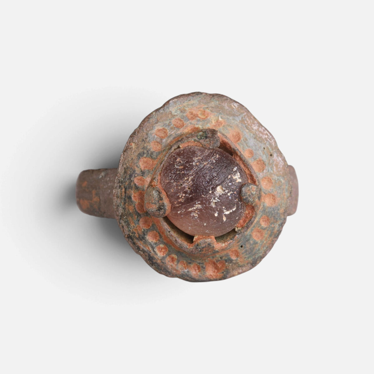 Byzantine bronze ring 'Porphyra' shows the purple setting and dotted border of its round bezel from the front.
