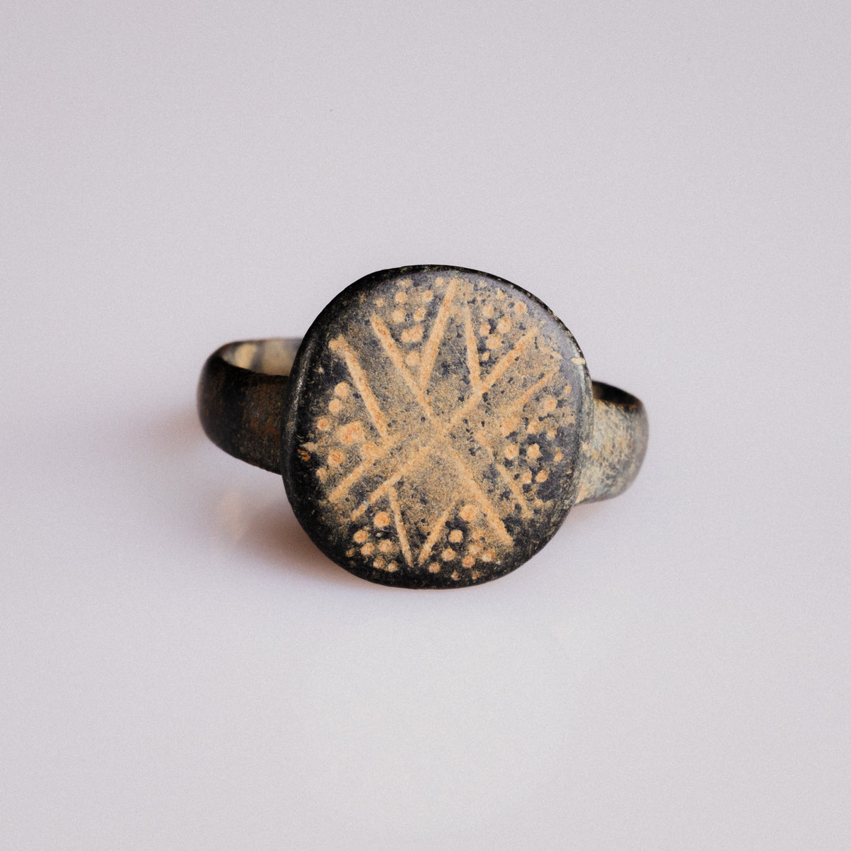 Byzantine bronze ring Stellaris on white background, engraved cross and dot bezel in full detail