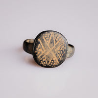 Byzantine bronze ring Stellaris on white background, engraved cross and dot bezel in full detail