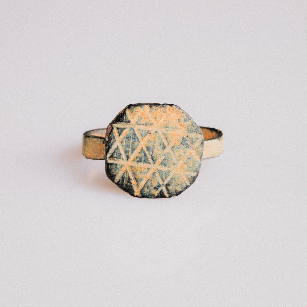 Byzantine bronze ring Theoktistos showing octagonal bezel with geometric lattice engraving