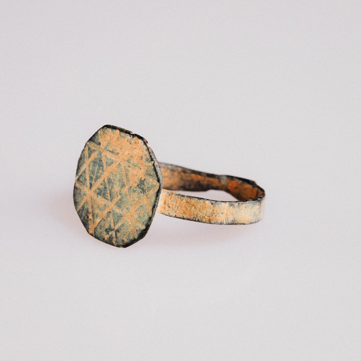 Byzantine bronze ring Theoktistos three-quarter view showing engraved geometric fields