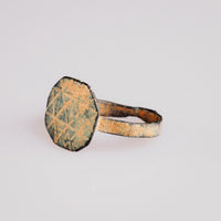 Byzantine bronze ring Theoktistos three-quarter view showing engraved geometric fields