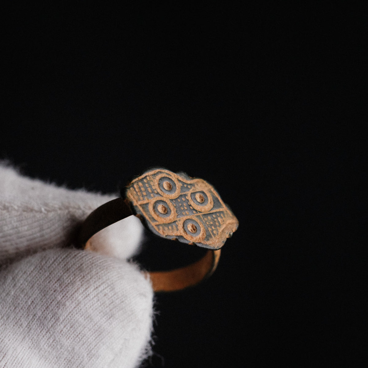 Byzantine bronze ring Theoxena close-up of ring-and-dot bezel decoration on dark background