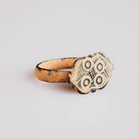 Byzantine bronze ring Theoxena showing bezel iconography and D-section hoop, angled view