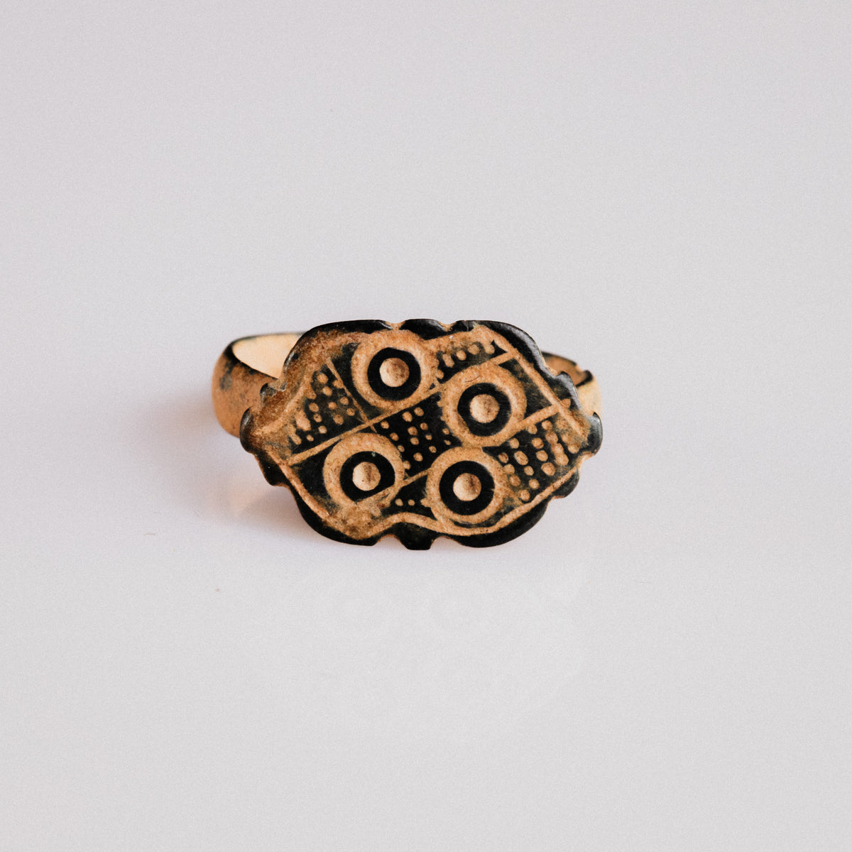 Byzantine bronze ring Theoxena with scalloped bezel and four ring-and-dot motifs, top view