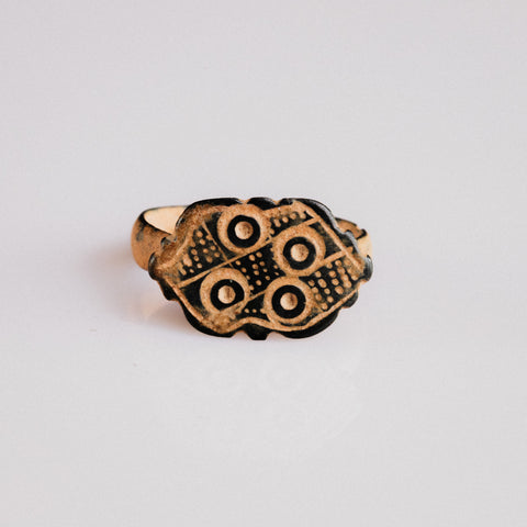 Byzantine bronze ring Theoxena with scalloped bezel and four ring-and-dot motifs, top view