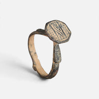 Byzantine bronze ring 'Damianos' shows its engraved octagonal bezel and complete hoop at an angle.