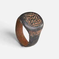 Byzantine bronze ring 'Kallisto' shows its geometric star device and full hoop at a higher angle.