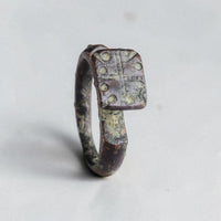 Byzantine bronze signet ring Kyros with cross-and-pellet bezel, three-quarter view