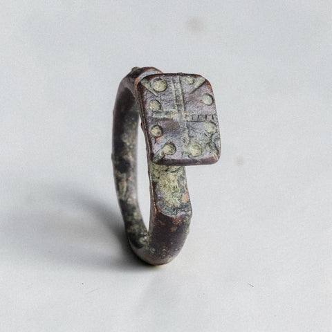 Byzantine bronze signet ring Kyros with cross-and-pellet bezel, three-quarter view