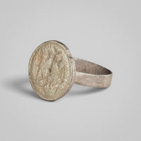 Byzantine silver ring Klados, angled view of the engraved device and circular border on the disc face.
