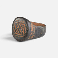Byzantine bronze ring 'Kallisto' shows its framed geometric bezel device from the opposite front angle.