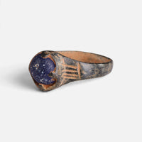 Byzantine bronze ring 'Kallinike' shows its blue setting and shoulder grooves from the opposite front angle.
