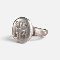 Byzantine silver ring 'Chrysanthos' shows its engraved circular bezel from the opposite front angle.