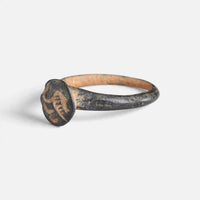 Byzantine bronze ring 'Peristerios' shows its circular bezel device from the opposite front angle.