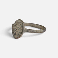 Byzantine bronze ring 'Kassia' shows its worn oval bezel device from the opposite front angle.
