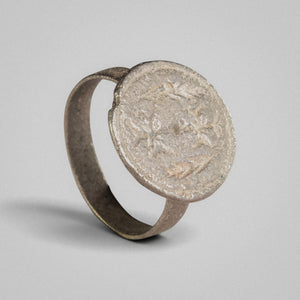 Byzantine silver ring Klados, three-quarter view showing disc bezel and narrow strip hoop.