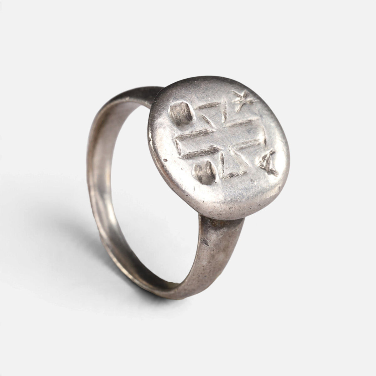 Byzantine silver ring 'Chrysanthos' shows its engraved circular bezel and complete hoop at an angle.