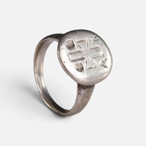 Byzantine silver ring 'Chrysanthos' shows its engraved circular bezel and complete hoop at an angle.