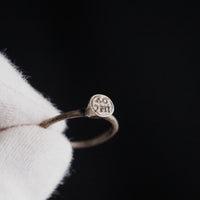 Byzantine silver ring Iesous held in gloved hand showing bezel with Greek letters