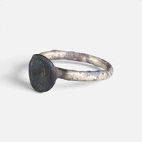 Byzantine ring 'Theodosia' shows its dark disc bezel face and worn hoop from the opposite angle.
