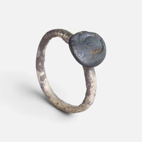 Byzantine ring 'Theodosia' shows its dark disc bezel and complete hoop at an angle.