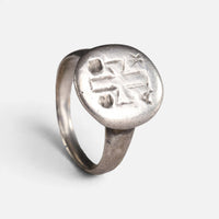 Byzantine silver ring 'Chrysanthos' shows its cross-like engraving and complete hoop at an angle.