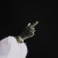 Close detail of the fist on Roman bronze pendant Manicula, folded fingers on either side of the thumb