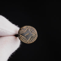 Close-up macro of medieval bronze ring Aldric showing incised Star of Bethlehem design
