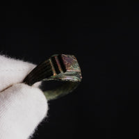 Close-up of Byzantine bronze ring Aetheria bezel showing engraved floral motif in raking light
