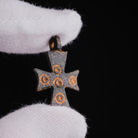 Close-up of medieval bronze cross pendant 'Okellaris' with quincunx ring-and-dot ornaments