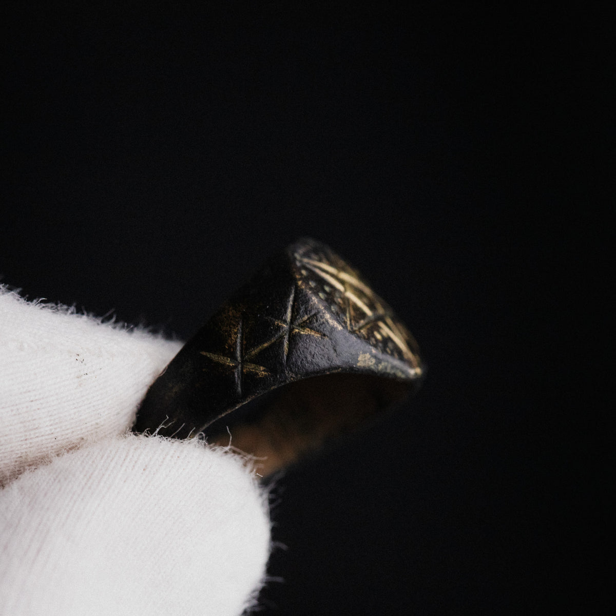 Close-up of medieval bronze ring Astariel shoulder with incised six-pointed stars