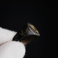 Close-up of medieval bronze ring Astariel shoulder with incised six-pointed stars