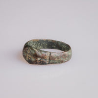 Close-up of medieval bronze ring Radenko bezel with softened cross pattée engraving.