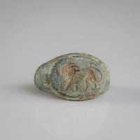 Close-up of Roman bronze ring Leonis lion bezel held in a gloved hand