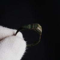 Close-up of Roman bronze ring Numerius bezel showing engraved cross or chi-form device