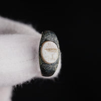 Close-up of Roman bronze ring Numerius intaglio bezel with footed pedestal engraving