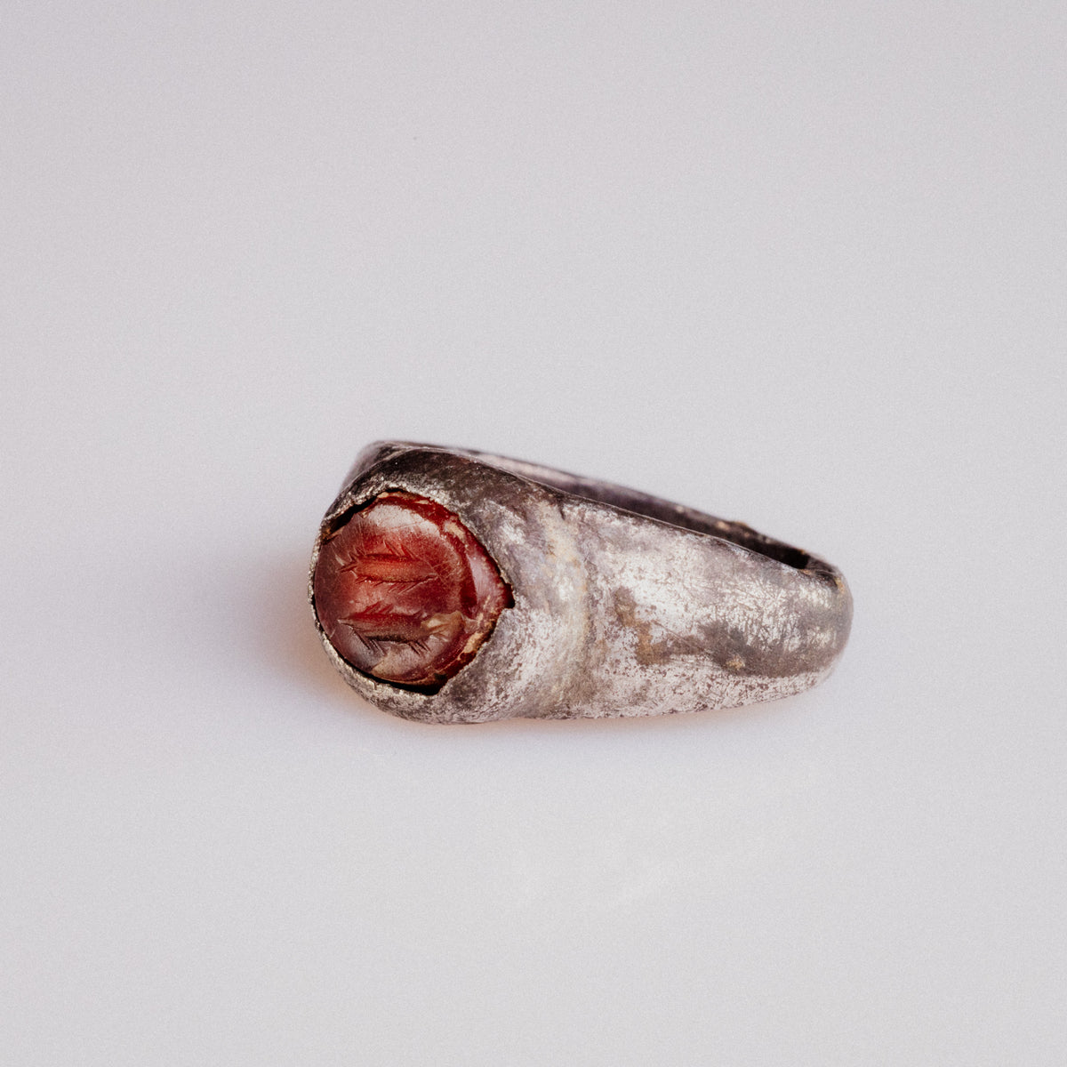 Close-up of Roman silver ring Pisculus carnelian intaglio engraved with fish