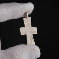 Close-up reverse detail of Peristeria silver cross pendant showing tarnish and burial patina