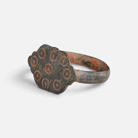 Medieval bronze ring 'Radvina' shows its ring-and-dot bezel decoration from the opposite front angle.