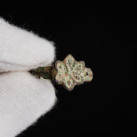 Detail macro of medieval bronze ring Florian showing the six-petalled rosette bezel