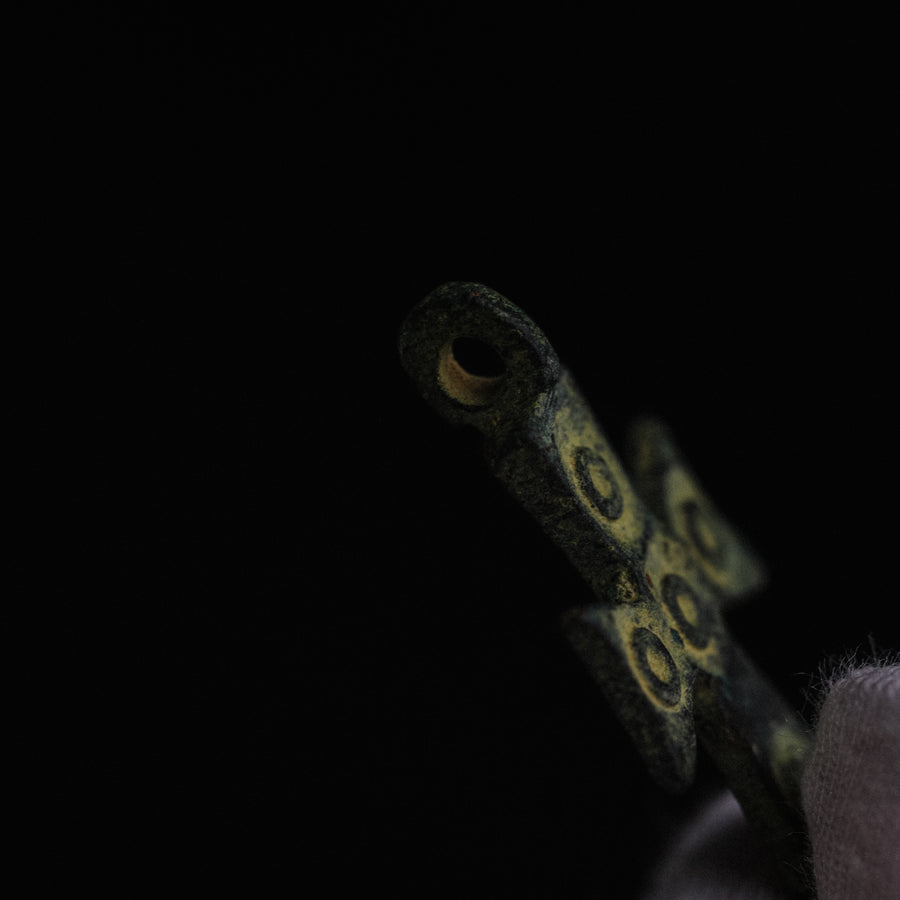Detail of integral tubular suspension loop on medieval bronze cross pendant 'Okellos'