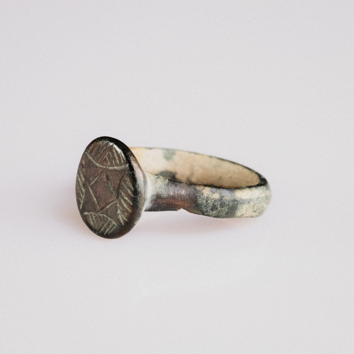 Detail of medieval bronze ring 'Aldric' bezel with lozenge and hatched petal motif