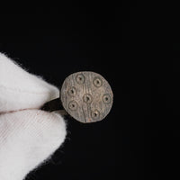 Detailed macro of medieval bronze ring Rurik bezel with eight annulet-and-pellet motifs