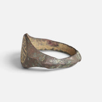 Medieval bronze ring 'Radwin' shows its bezel edge and tapering hoop from the side.
