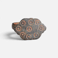Medieval bronze ring 'Radvina' shows circular ring-and-dot marks across the face of its lobed bezel.