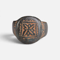 Byzantine bronze ring 'Kallisto' shows a geometric star device inside an engraved square border.
